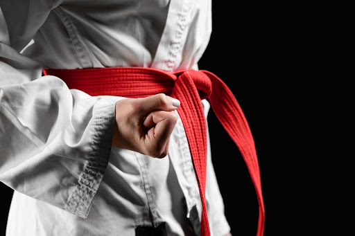 close-up-to-a-person-wearing-a-martial-arts-uniform-with-a-red-belt