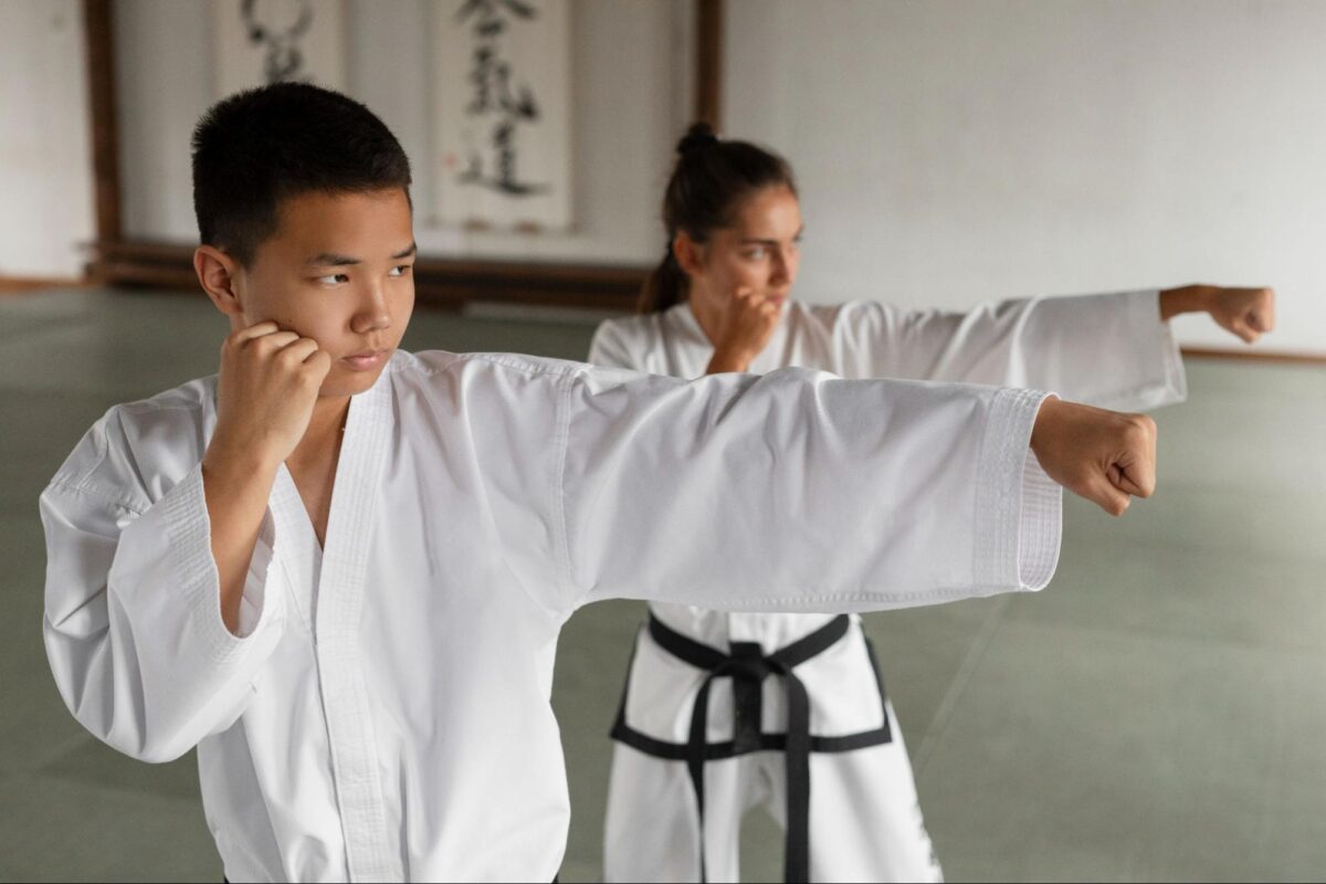 A boy and a girl practicing martial arts in an Etobicoke martial arts gym.