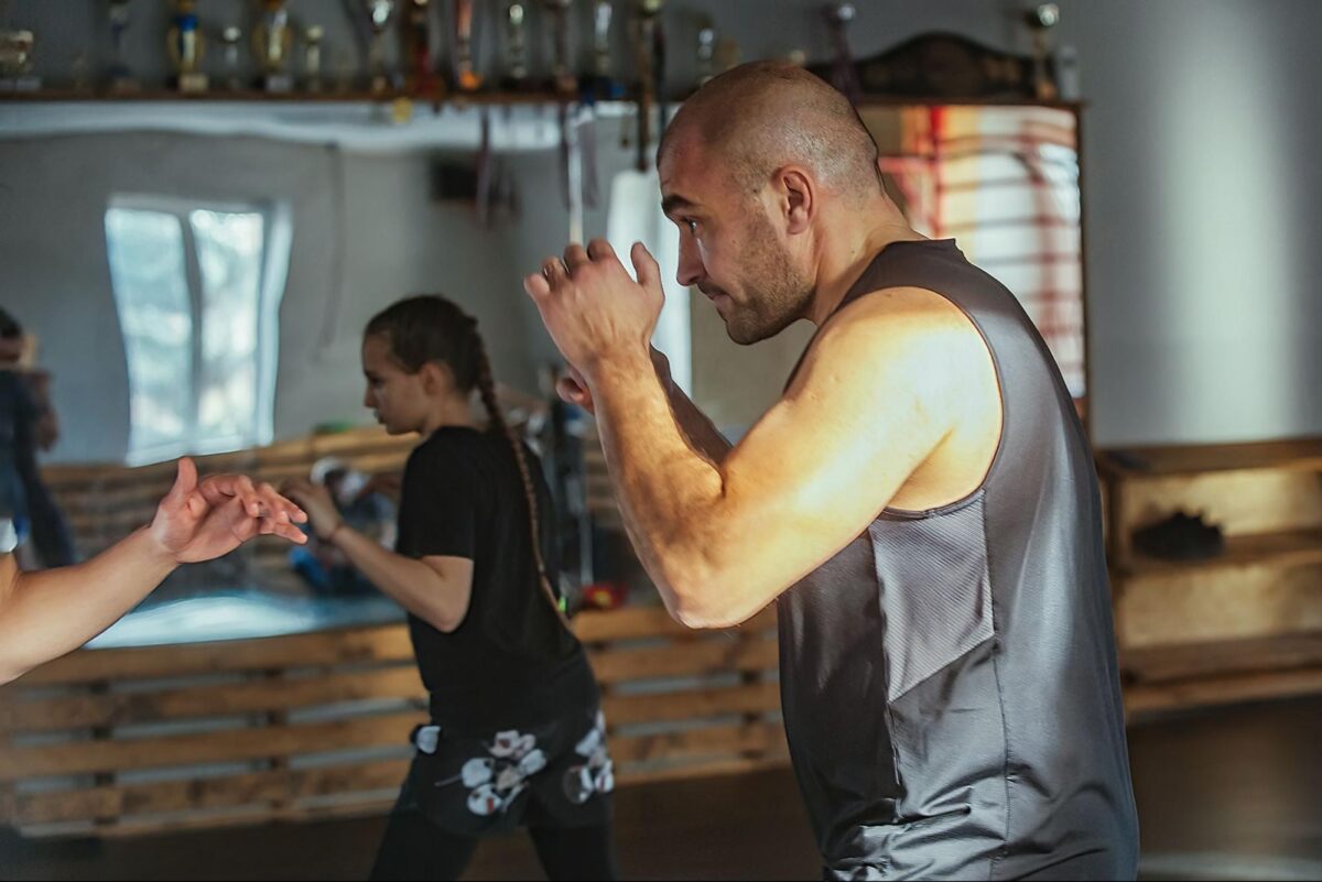 Adult beginner martial arts striking class with instructor coaching at Etobicoke gym